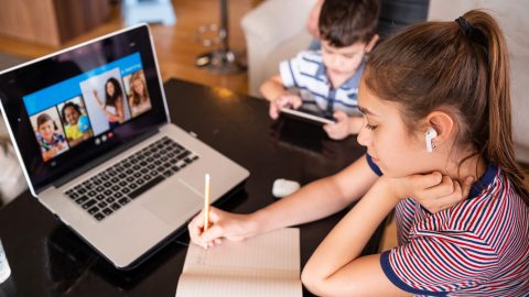 Teenage girl studying with video online lesson at home family in isolation Homeschooling and distance learning